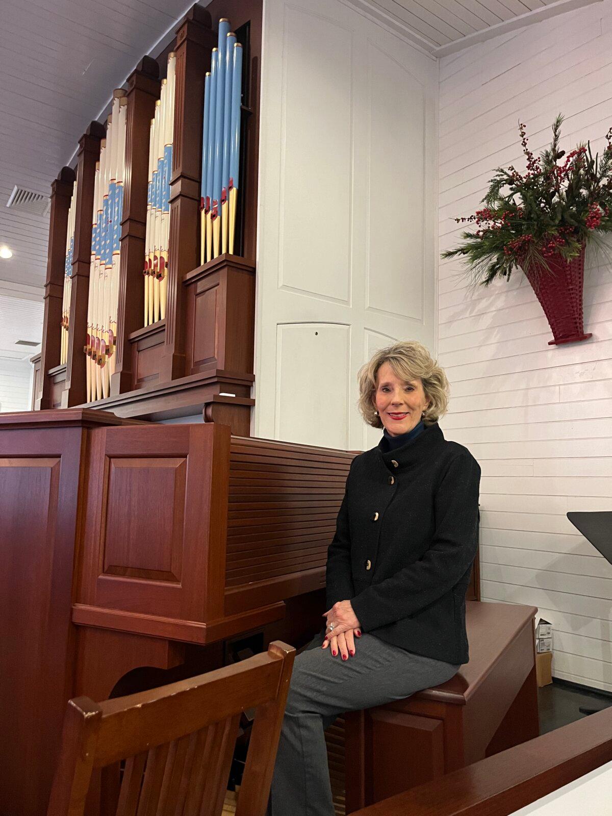 Angela Jenkins beside the pipe organ she plays at the First Presbyterian Church of Highlands. (Courtesy of Deena Bouknight)