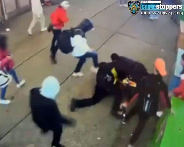 Video still shows a group of illegal immigrants attacking two New York police officers outside a shelter, on Jan. 27, 2024. (New York Police Department)