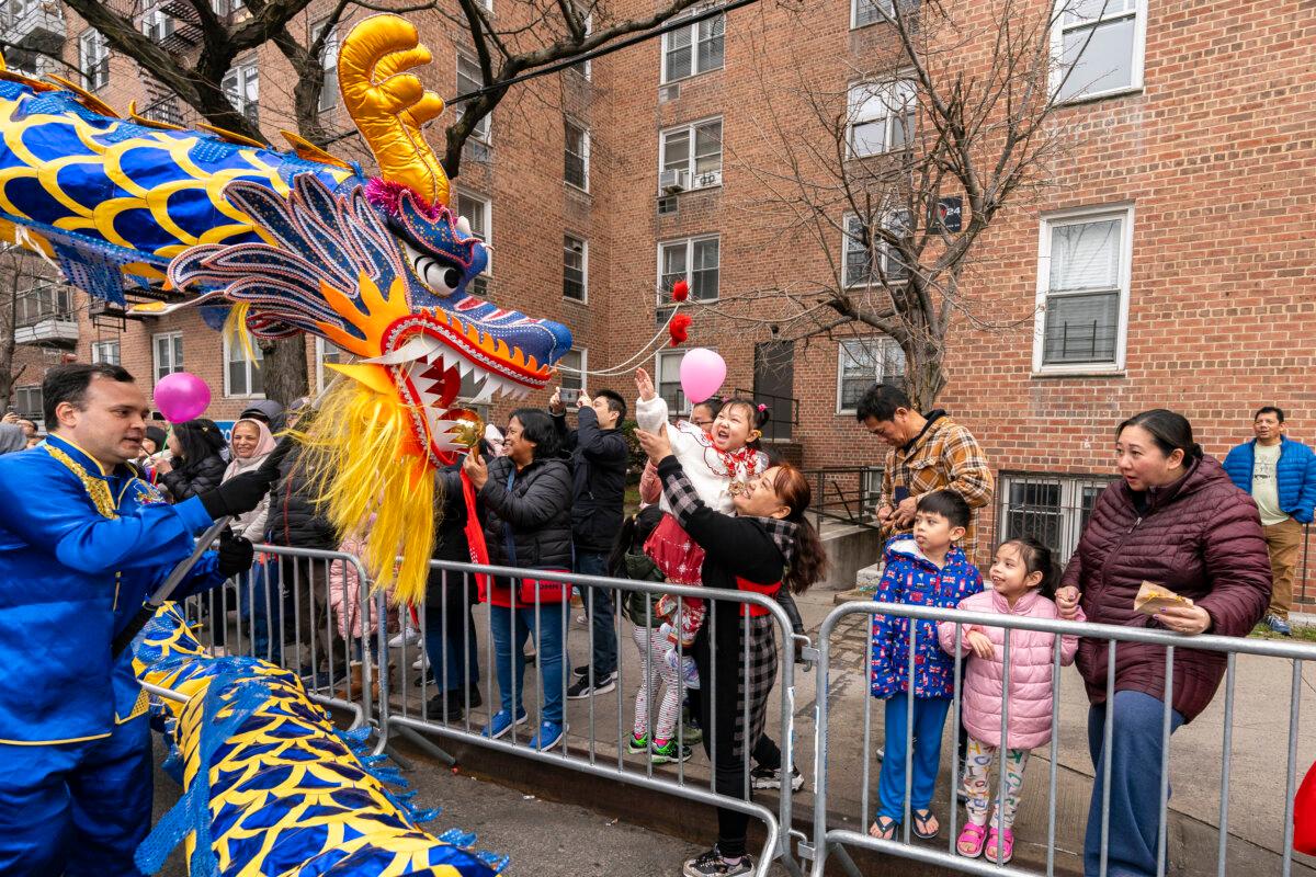 Falun Gong practitioners attend a parade celebrating the Chinese New Year in the Flushing neighborhood of Queens, N.Y., on Feb. 10, 2024. (Samira Bouaou/The Epoch Times)