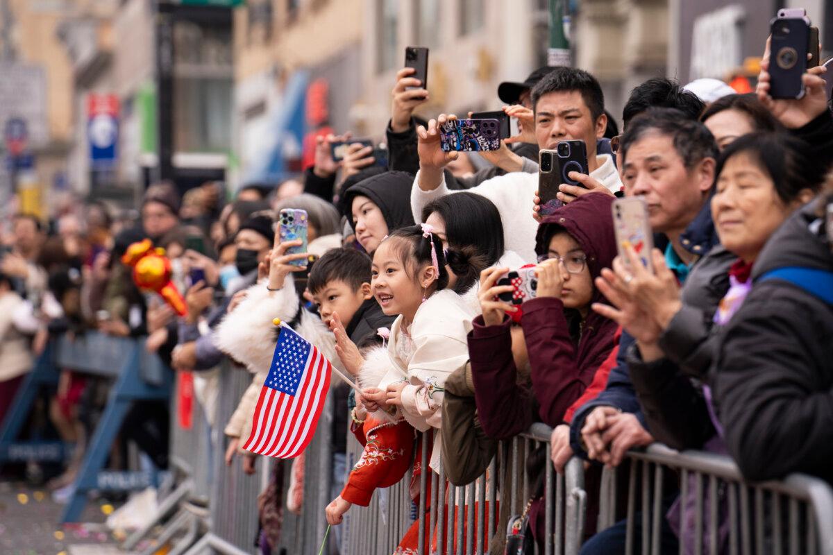 Spectators watch as Falun Gong practitioners attend a parade celebrating the Chinese New Year in the Flushing neighborhood of Queens, N.Y., on Feb. 10, 2024. (Samira Bouaou/The Epoch Times)