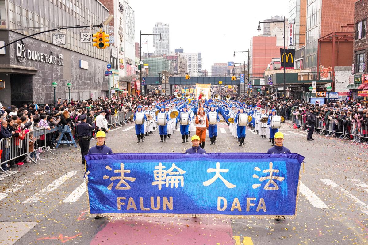 Falun Gong practitioners attend a parade celebrating the Chinese New Year in the Flushing neighborhood of Queens, N.Y., on Feb. 10, 2024. (Larry Dye/The Epoch Times)