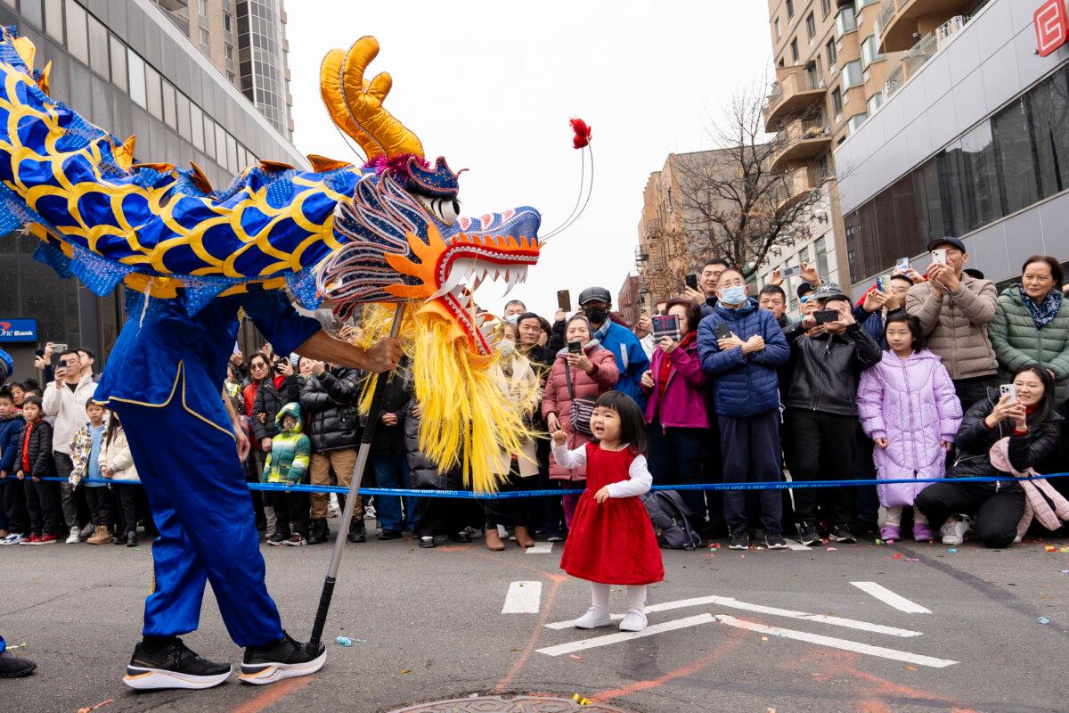 Falun Gong practitioners attend a parade celebrating the Chinese New Year in the Flushing neighborhood of Queens, N.Y., on Feb. 10, 2024. (Samira Bouaou/The Epoch Times)