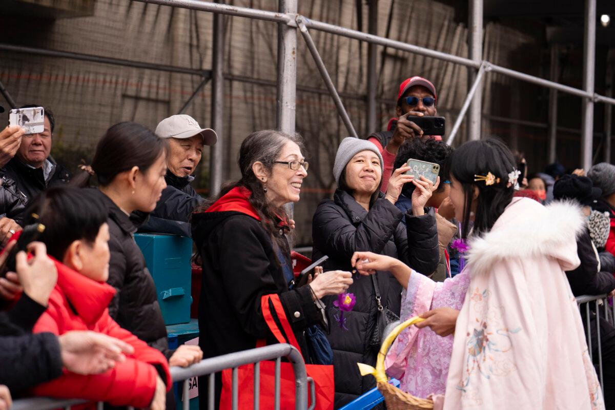 Falun Gong practitioners attend a parade celebrating the Chinese New Year in the Flushing neighborhood of Queens, N.Y., on Feb. 10, 2024. (Samira Bouaou/The Epoch Times)