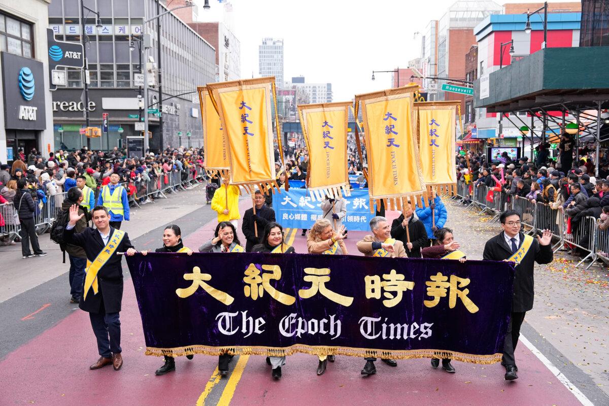 The Epoch Times staff attend a parade celebrating the Chinese New Year in the Flushing neighborhood of Queens, N.Y., on Feb. 10, 2024. (Larry Dye/The Epoch Times)