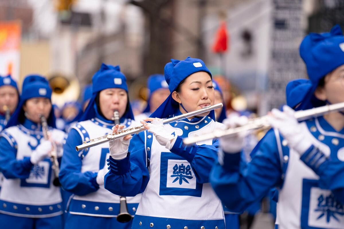 Falun Gong practitioners attend a parade celebrating the Chinese New Year in the Flushing neighborhood of Queens, N.Y., on Feb. 10, 2024. (Samira Bouaou/The Epoch Times)