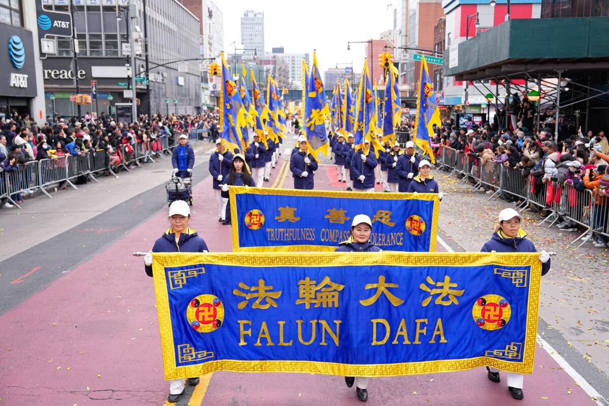 Falun Gong practitioners attend a parade celebrating the Chinese New Year in the Flushing neighborhood of Queens, N.Y., on Feb. 10, 2024. (Larry Dye/The Epoch Times)