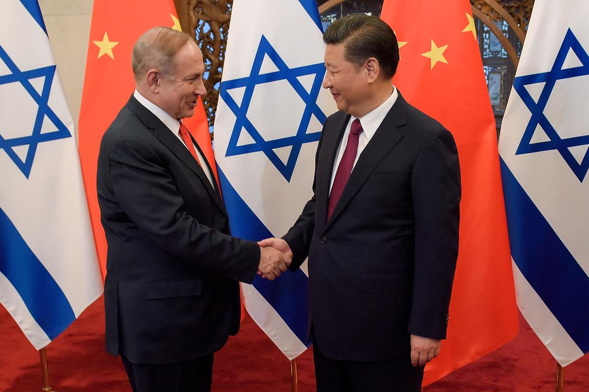 Israel's Prime Minister Benjamin Netanyahu and Chinese leader Xi Jinping shake hands ahead of their talks at Diaoyutai State Guesthouse in Beijing, on March 21, 2017. (Etienne Oliveau/AFP via Getty Images)