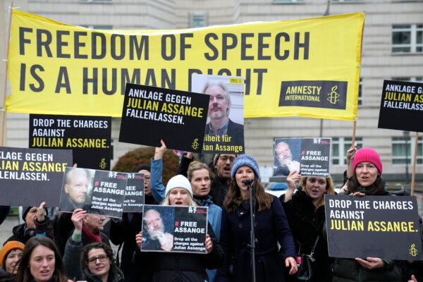 Demonstrators hold banners during a rally in support of Julian Assange in front of the U.S embassy in Berlin, on Feb. 20, 2024. (Ebrahim Noroozi/AP Photo)