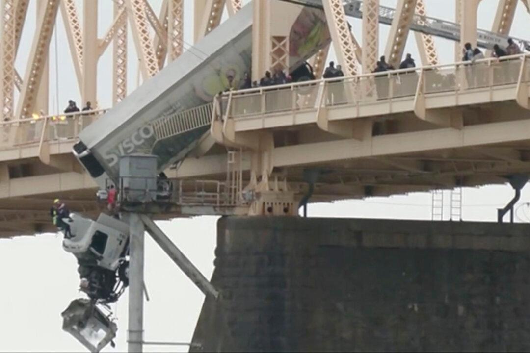 Truck Driver Pulled to Safety After Crash Leaves Vehicle Dangling Over Bridge Across Ohio River