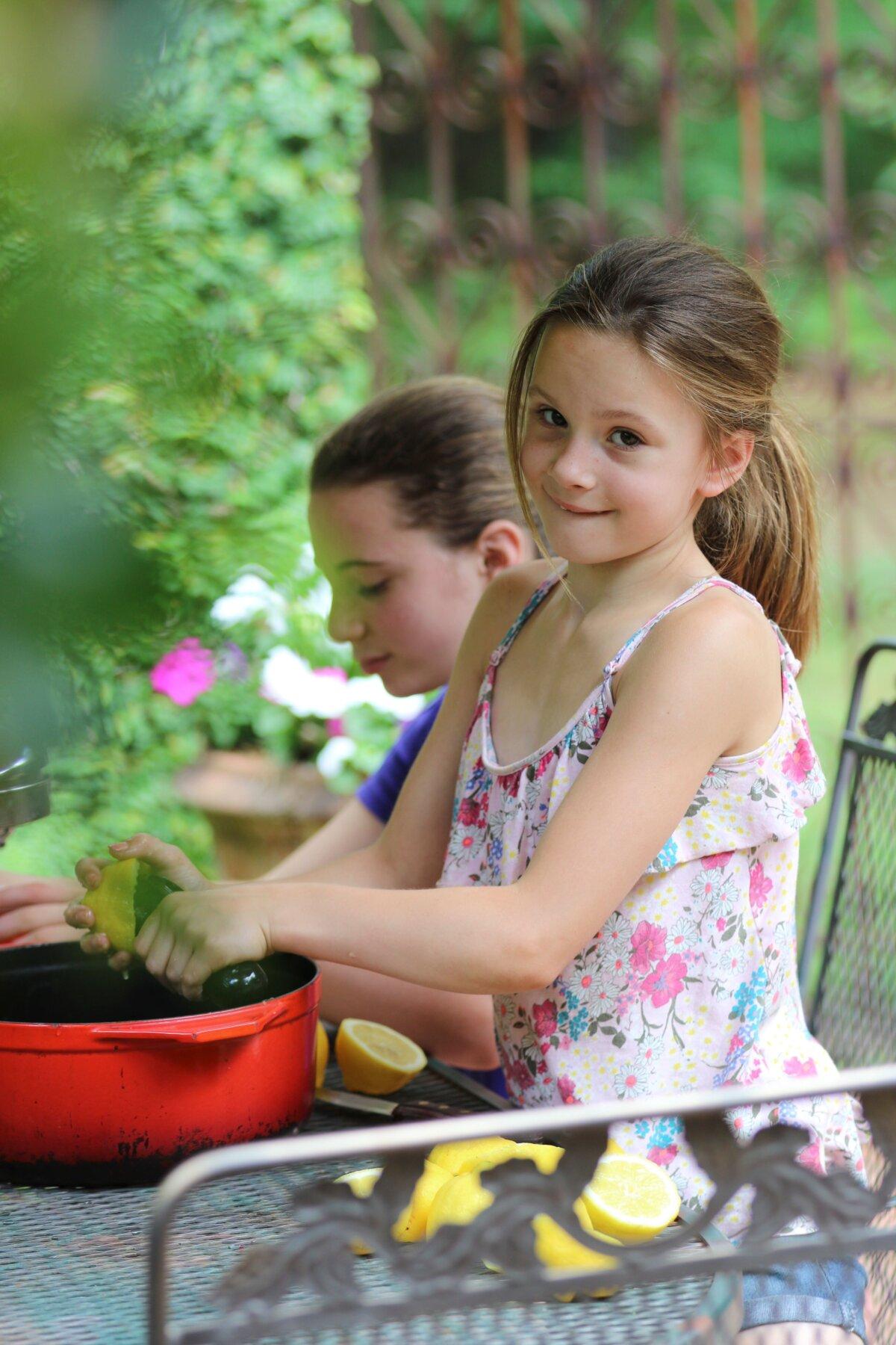 Ms. Harris's daughters Anna and Milly make lemonade for a luncheon in their courtyard. (Courtesy of Stacy Lyn Harris)