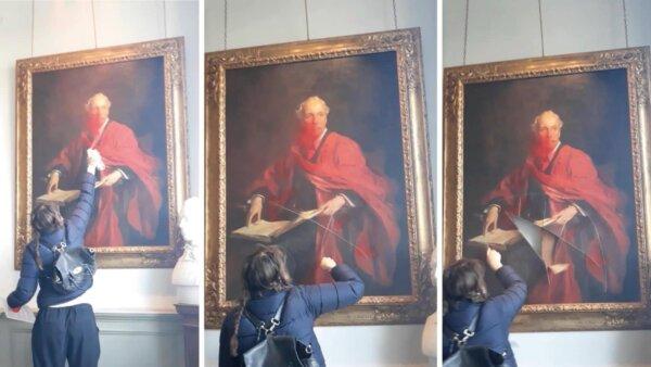 A Palestine Action activist vandalising a painting of Lord Balfour at the University of Cambridge in Cambridge, England, on March 8, 2024. (Courtesy of Palestine Action)