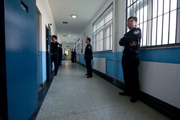 Police guards stand in a hallway inside the No.1 Detention Center during a government-guided tour in Beijing on October 25, 2012. The facility has the capacity for 1,000 inmates (Ed Jones/AFP via Getty Images)