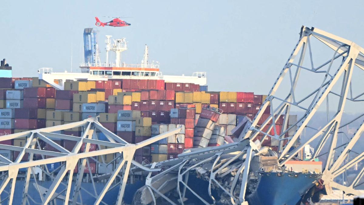 The steel frame of the Francis Scott Key Bridge sit on top of a container ship after the bridge collapsed collapsed in Baltimore, Maryland, on March 26, 2024. The bridge collapsed after being struck by a container ship, sending multiple vehicles and up to 20 people plunging into the harbor below. (Mandel Ngan/AFP via Getty Images)
