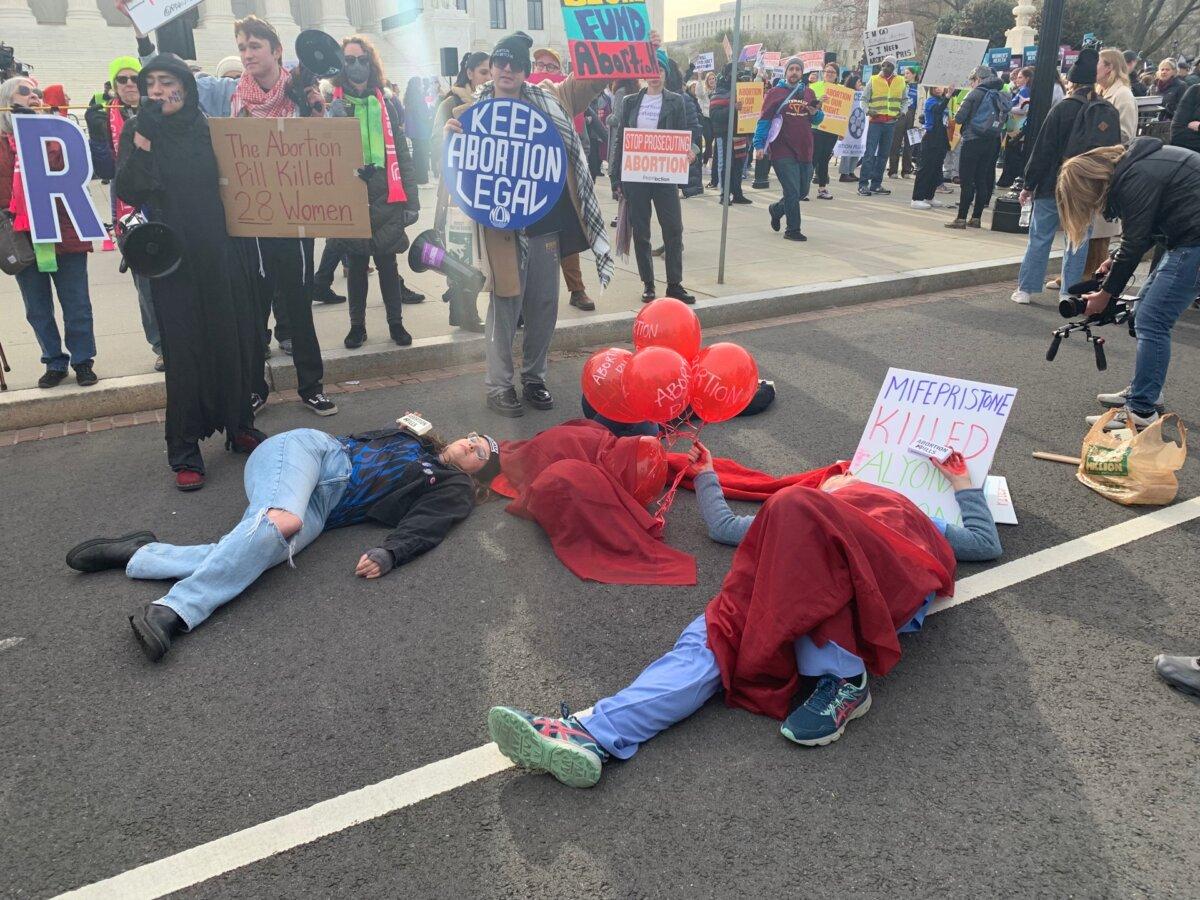 Pro-life protesters stage a 'die-in' outside the Supreme Court ahead of a major challenge to abortion pill access, on March 26, 2024. (Sam Dorman/The Epoch Times)