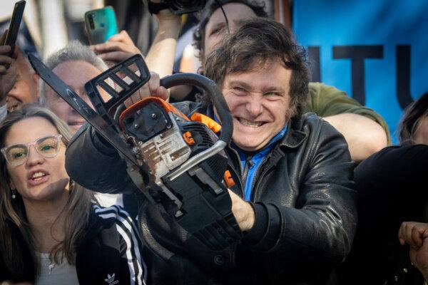 Then-presidential candidate Javier Milei lifts a chainsaw during a campaign rally in Buenos Aires, Argentina, on Sept. 25, 2023. (Tomas Cuesta/Getty Images)