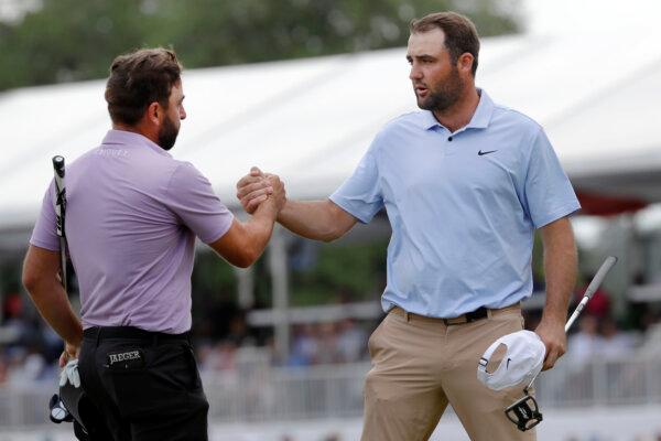 Stephan Jaeger (L) and Scottie Scheffler shake hands after finishing the Houston Open golf tournament in Houston on March 31, 2024.(Michael Wyke/AP Photo)