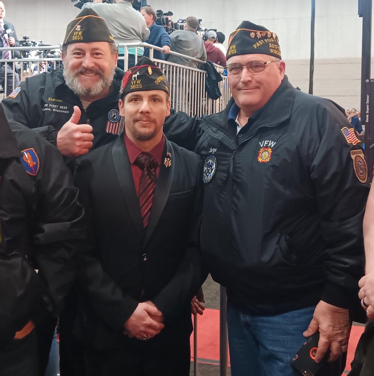 Steven Levine (L), Aaron Volling (C), and Richard Verheyen (R) were among the military veterans gathered to hear President Trump speak in Green Bay, Wis., on April 2, 2024. (Nathan Worcester/The Epoch Times)