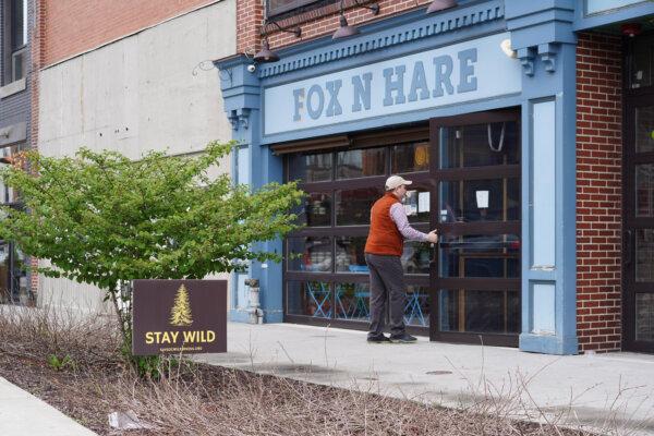 A "Stay Wild" sign for the Delaware River watershed preservation campaign by Orange County Land Trust in downtown Port Jervis, N.Y., on April 18, 2024. (Cara Ding/The Epoch Times)