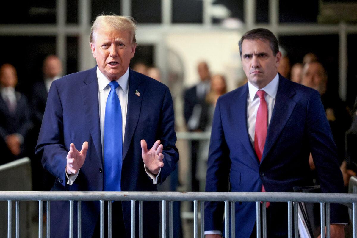 Former President and Republican presidential candidate Donald Trump, flanked by lawyer Todd Blanche (R), arrives at Manhattan Criminal Court in New York on April 22, 2024. (Brendan McDermid/Pool/AFP via Getty Images)