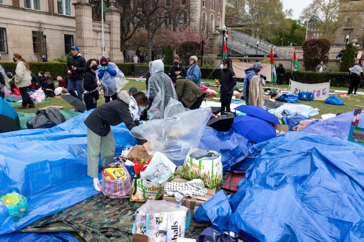 Pro-Palestinian students and activists prepare for rain as they camp out on the campus of Columbia University in New York City on April 19, 2024. (Alex Kent/AFP via Getty Images)