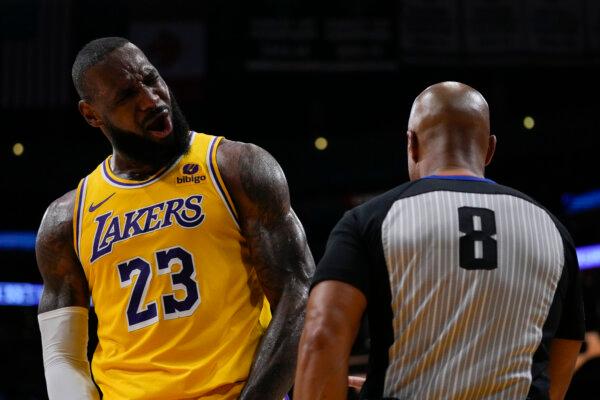 Lakers star LeBron James disputes a foul call with referee Marc Davis during NBA playoff action against the Nuggets in Los Angeles on April 25, 2024. (Ashley Landis/AP Photo)