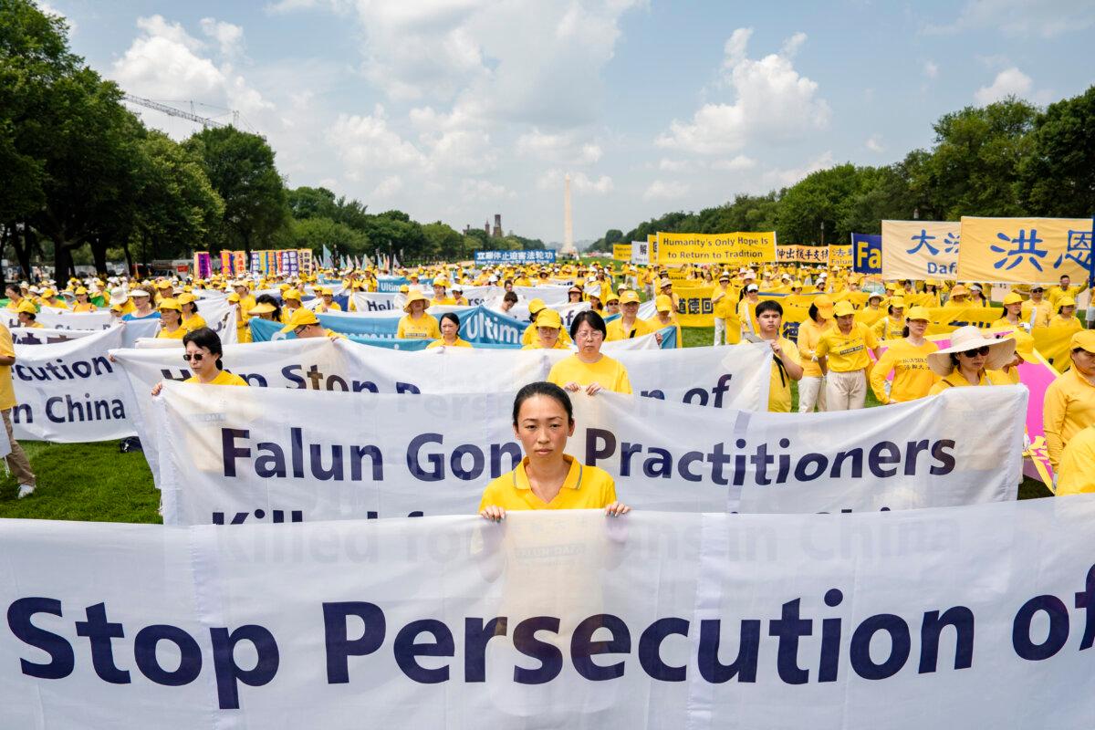 Falun Gong practitioners call for an end to the persecution of the spiritual group in China, during an event marking 24 years since the start of the persecution, on Capitol Hill, on July 20, 2023. (Samira Bouaou/The Epoch Times)