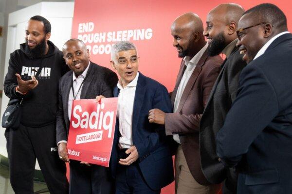 Mayor of London Sadiq Khan jokes with local Labour councillors during a visit to St. John's Church in Waterloo, London, on April 15, 2024. (PA Wire)