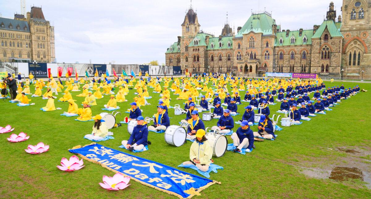Falun Gong adherents demonstrate a mediative exercise at Parliament Hill during the "Falun Dafa Day" celebration in Ottawa on May 8, 2024. (Jonathan Ren/The Epoch Times)