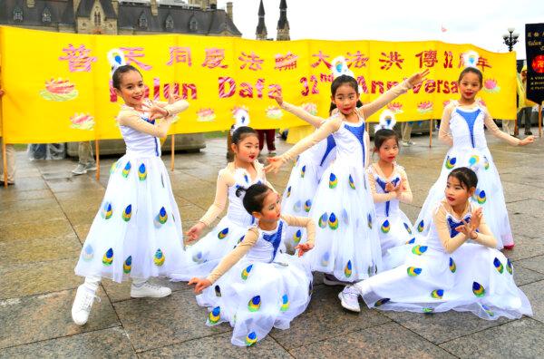 Young Falun Dafa practitioners perform a cultural dance during Falun Dafa Day celebrations on Parliament Hill in Ottawa on May 7, 2024. (Jonathan Ren/The Epoch Times)