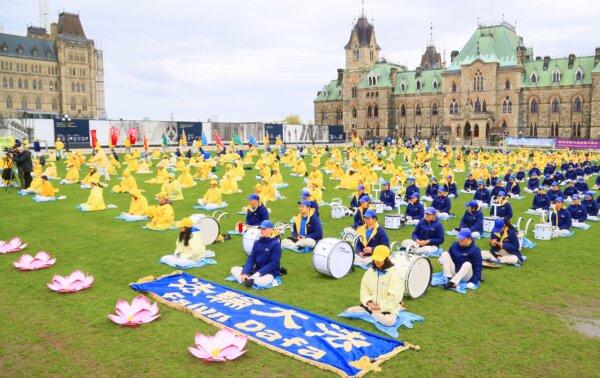 Falun Gong adherents demonstrate a meditative exercise on Parliament Hill during Falun Dafa Day celebrations in Ottawa on May 8, 2024. (Jonathan Ren/The Epoch Times)