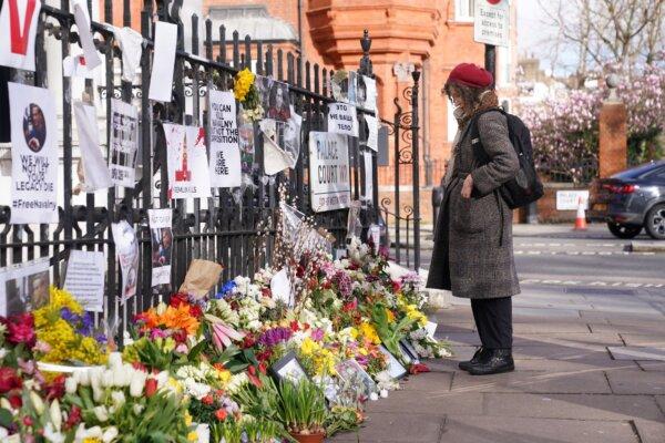 A person looks at flowers and tributes to opposition leader Alexei Navalny, outside the Russian Embassy in London, on March 1, 2024. (Lucy North/PA Wire)