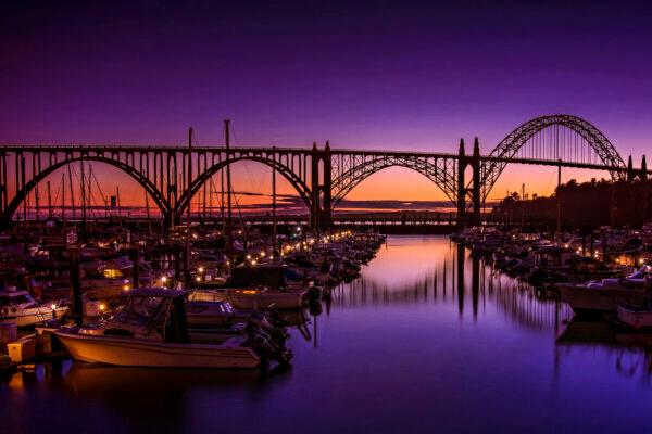 Newport’s Embarcadero Marina and Yaquina Bay Bridge silhouetted at sunset. (Maria Coulson)