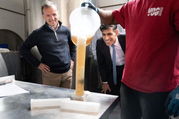 Prime Minister Rishi Sunak (R) observes beer being poured at the Vale of Glamorgan Brewery in Barry, south Wales on May 23, 2024. (PA Wire)