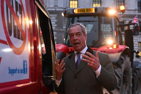 Nigel Farage speaks to the driver of a van taking part in a protest against the ULEZ charge near the Houses of Parliament in London on March 25, 2024. (Leon Neal/Getty Images)