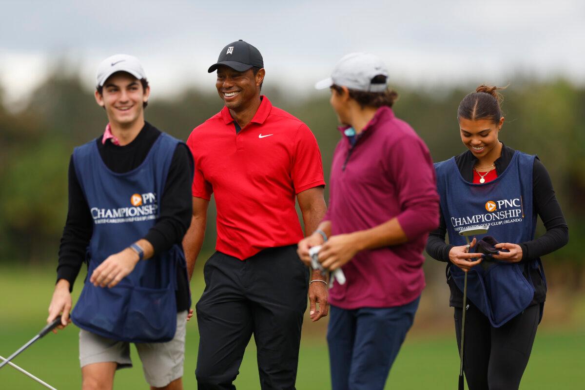Tiger Woods of the United States walks off the 16th green with son Charlie Woods, daughter Sam Woods, and caddie Luke Wise on the 15th green during the final round of the PNC Championship at The Ritz-Carlton Golf Club in Orlando, Florida, on December 17, 2023. (Mike Ehrmann/Getty Images)