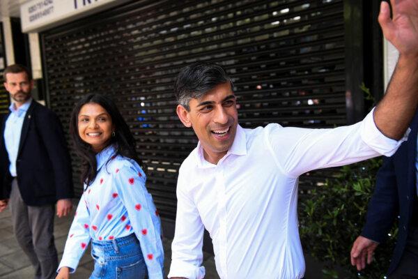 Prime Minister Rishi Sunak (R) and his his wife Akshata Murty leave after a campaign event in Stanmore, north west London, on May 26, 2024. (Chris J Ratcliffe/PA Wire)