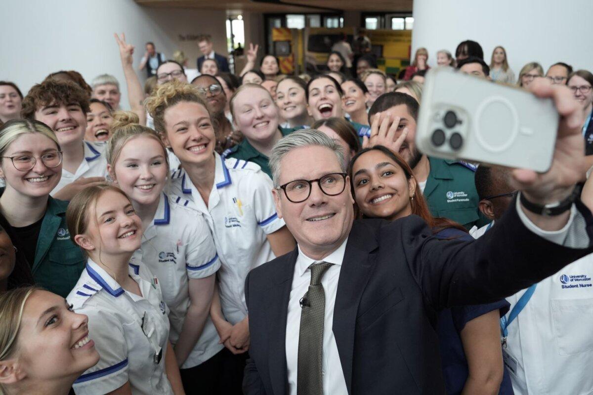 Labour Party leader Sir Keir Starmer takes a selfie with student nurses and trainee medics during a visit to Three Counties Medical School in Worcester, England, on May 29, 2024. (Stefan Rousseau/PA Wire)