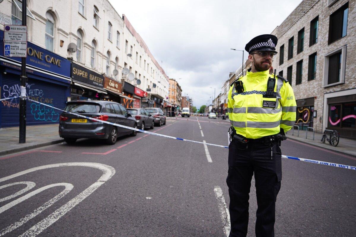 A police officer at the scene of a shooting at Kingsland High Street, Hackney, east London, on May 30, 2024. (James Manning/PA)