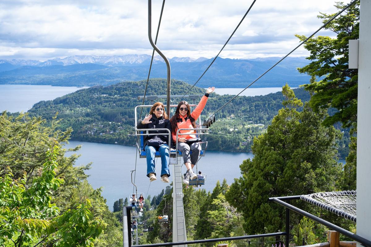 Two women enjoy the view from the chairlift. (Jose de Jesus Churion Del/Shutterstock)