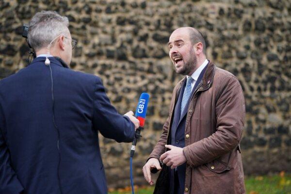Conservative Party Chairman Richard Holden does a media interview about the Rwanda policy on College Green in Westminster, London, on Dec. 12, 2023. (PA)