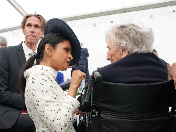 Prime Minister Rishi Sunak's wife, Akshata Murty (L), speaks with D-Day veteran Christian Lamb (R), who was presented earlier with the Legion d'Honneur, during a lunch at the British Normandy Memorial in Ver-sur-Mer, France, on June 6, 2024. (Gareth Fuller/PA)