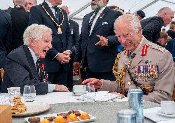 King Charles III (R) laughs with D-Day veteran Peter Newton (L) during a lunch in Ver-sur-Mer, France, on June 6, 2024. (Arthur Edwards/The Sun/PA)