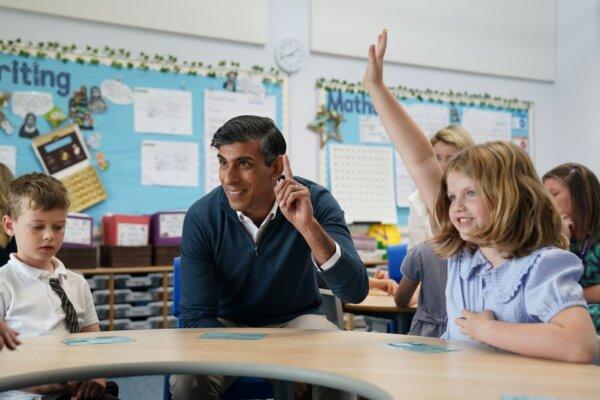 Prime Minister Rishi Sunak puts his hand up during a visit to a classroom in Stonehouse, Gloucestershire, England on June 7, 2024. (PA)