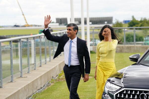 Prime Minister Rishi Sunak arrives with his wife Akshata Murty for the launch the Conservative Party general election manifesto at Silverstone race track in Northamptonshire, England, on June 11, 2024. (James Manning/PA Wire)