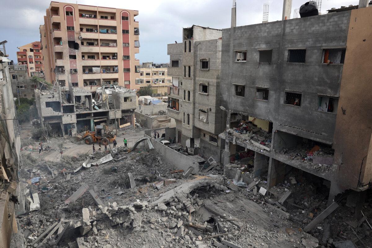 Palestinians inspect the damage and debris a day after an operation by the Israeli special forces in the Nuseirat camp in the central Gaza Strip on June 9, 2024. (Eyad Baba/Getty Images)