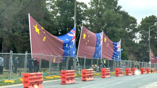 Pro-CCP organisers erecting flags at the back of the Hyatt Hotel Canberra where Premier Li Qiang will be staying, taken in Canberra, Australia on June 14, 2024. (Courtesy of Songfa Liu)