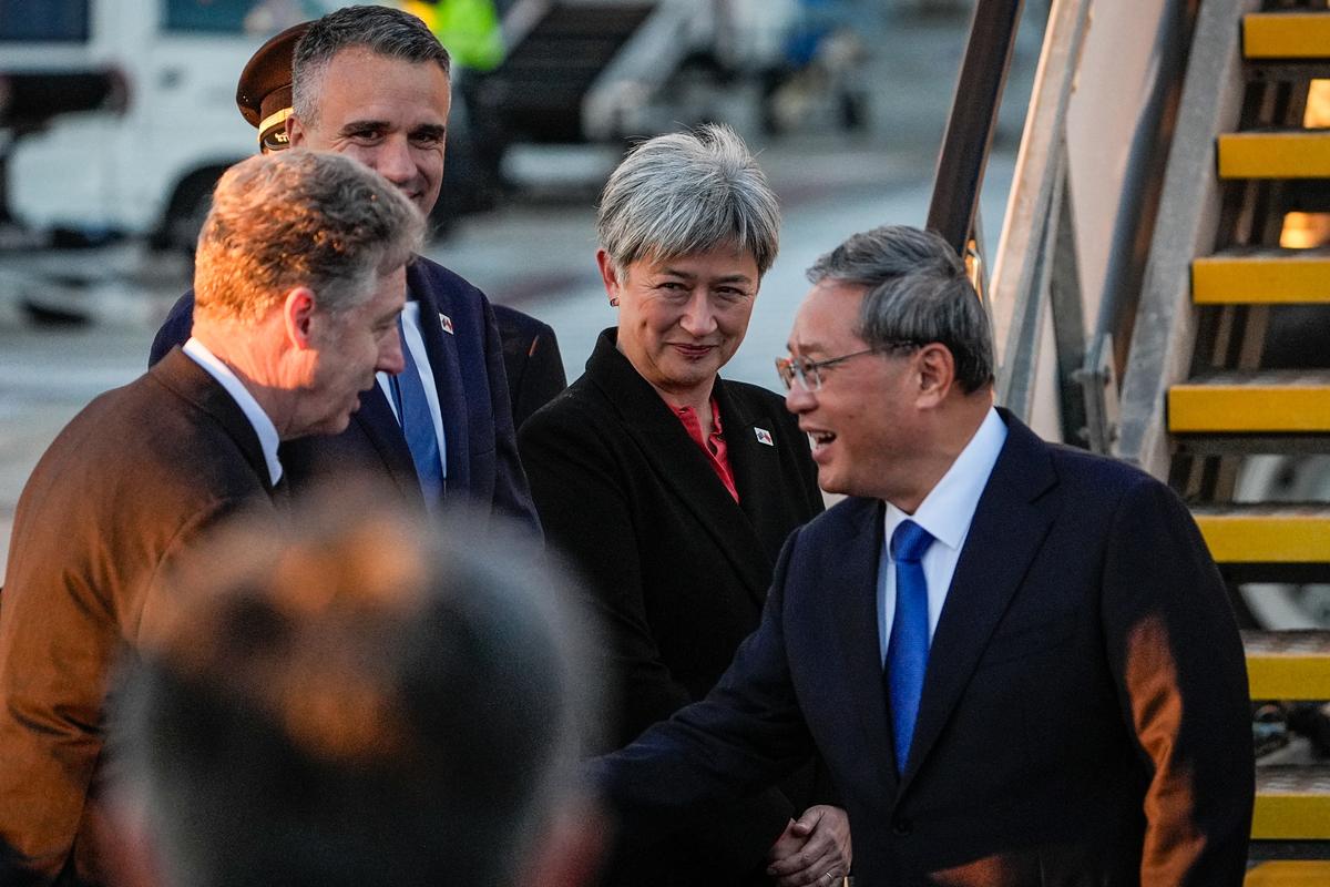CCP's Premier Li Qiang (R) greets Australia's Foreign Minister Penny Wong (C), South Australia's Premier Peter Malinauskas (2nd L) and other officials at Adelaide Airport in Adelaide, Australia on June 15, 2024. (Asanka Ratnayake/Pool/AFP via Getty Images)