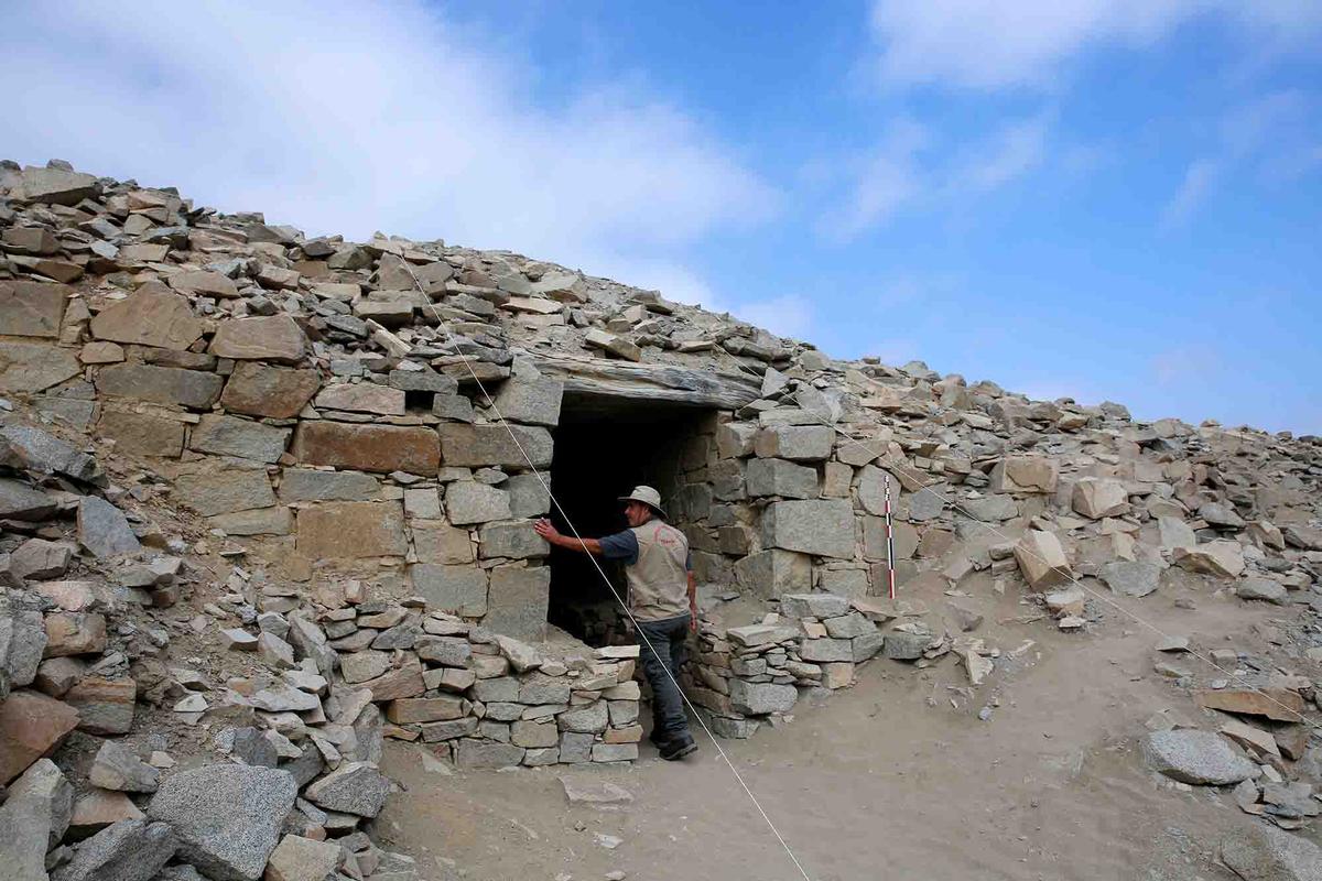A researcher examines a structure at Chankillo. (Janine Costa/AFP via Getty Images)