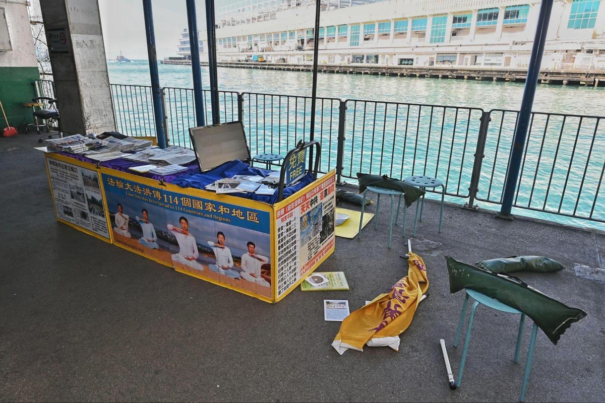 The Falun Gong information booth as seen after Mr. Hu threw a display board into the sea and smashed the computer rack and other items at the Star Ferry Pier, in Hong Kong, on Dec. 20, 2020. (Sung Pi-lung/The Epoch Times)