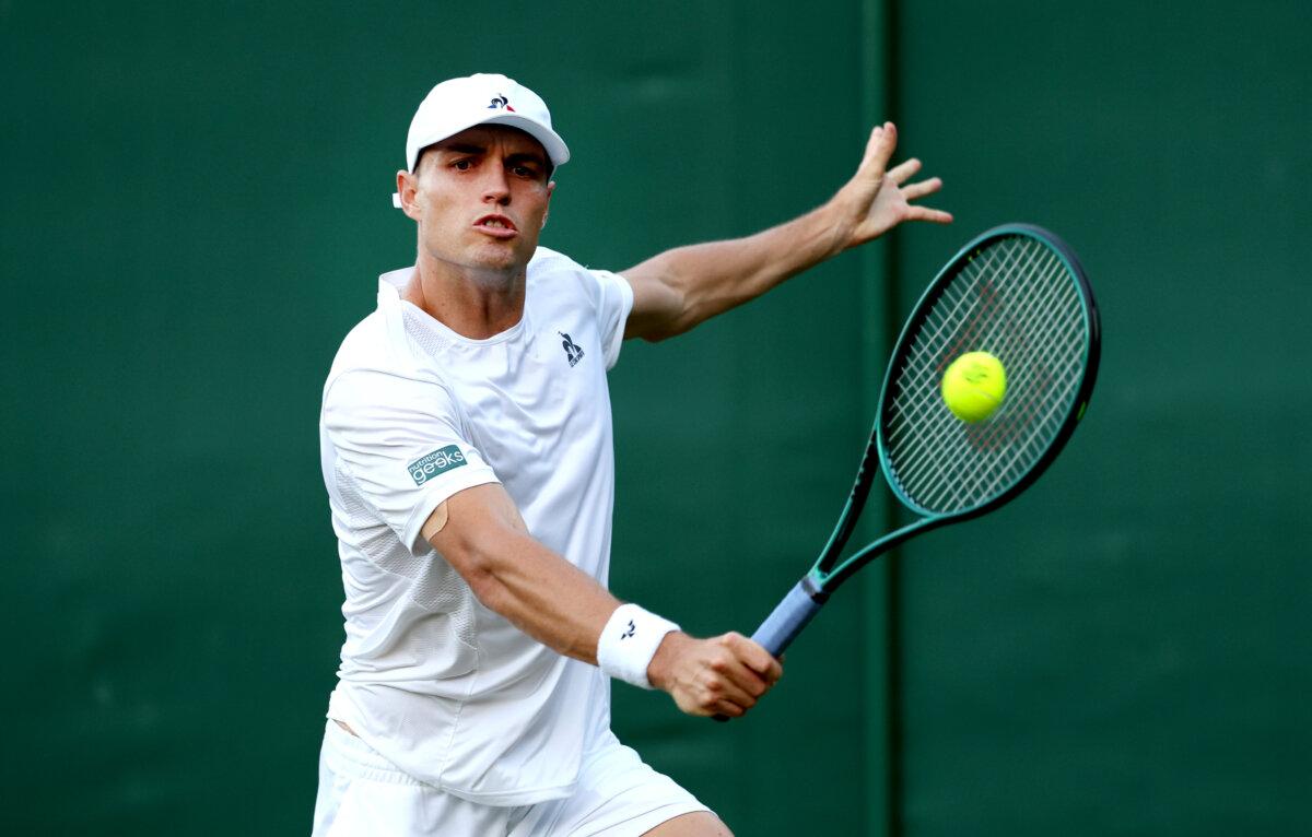 Christopher O'Connell of Australia plays a backhand against Taylor Fritz of the United States in his Gentlemen's Singles first round match during day two of The Championships Wimbledon 2024 at All England Lawn Tennis and Croquet Club in London on July 2, 2024. (Julian Finney/Getty Images)
